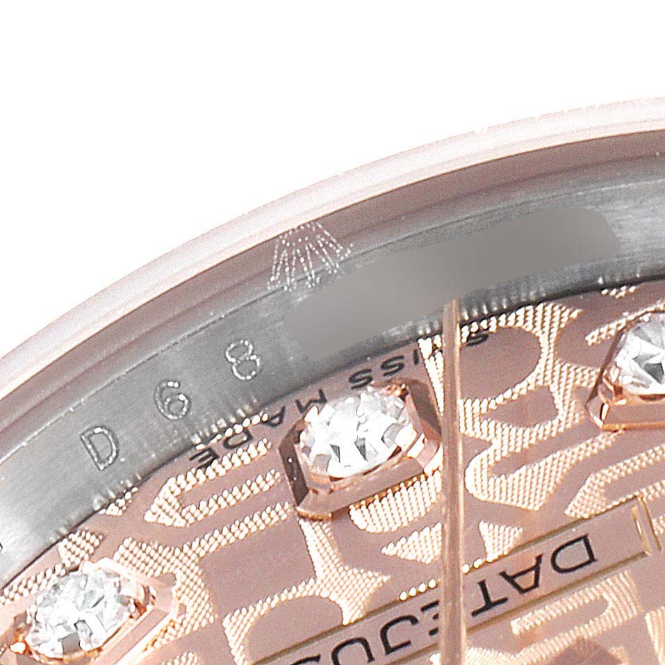 This close-up angle shows the bezel, part of the dial, and diamond hour markers of a Rolex Datejust 179171 Women's Rose Gold Pink Dial 179171 Women's Rose Gold Pink Dial watch.