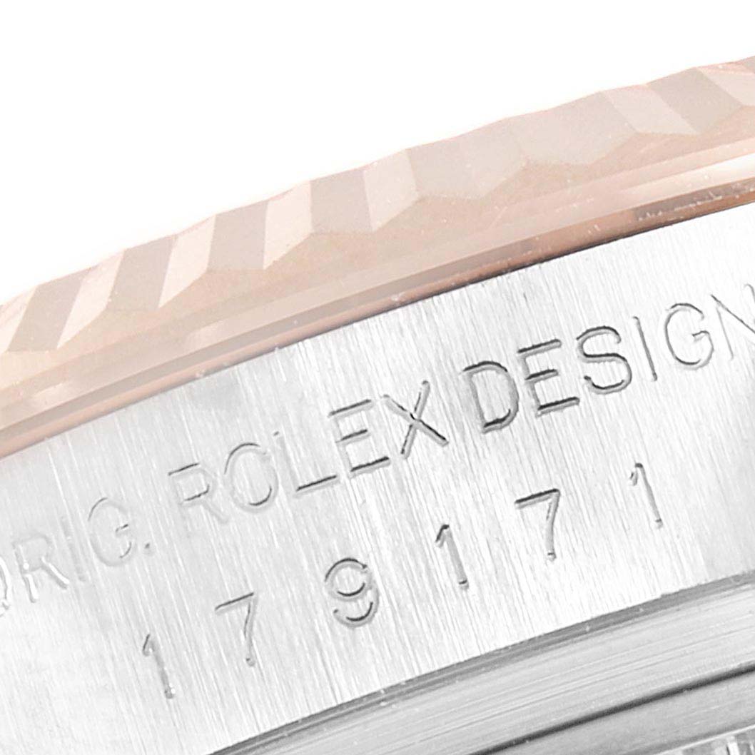 The image shows a close-up of the Rolex Datejust 179171 Women's Rose Gold Pink Dial 179171 Women's Rose Gold Pink Dial bezel and part of the engraved case.