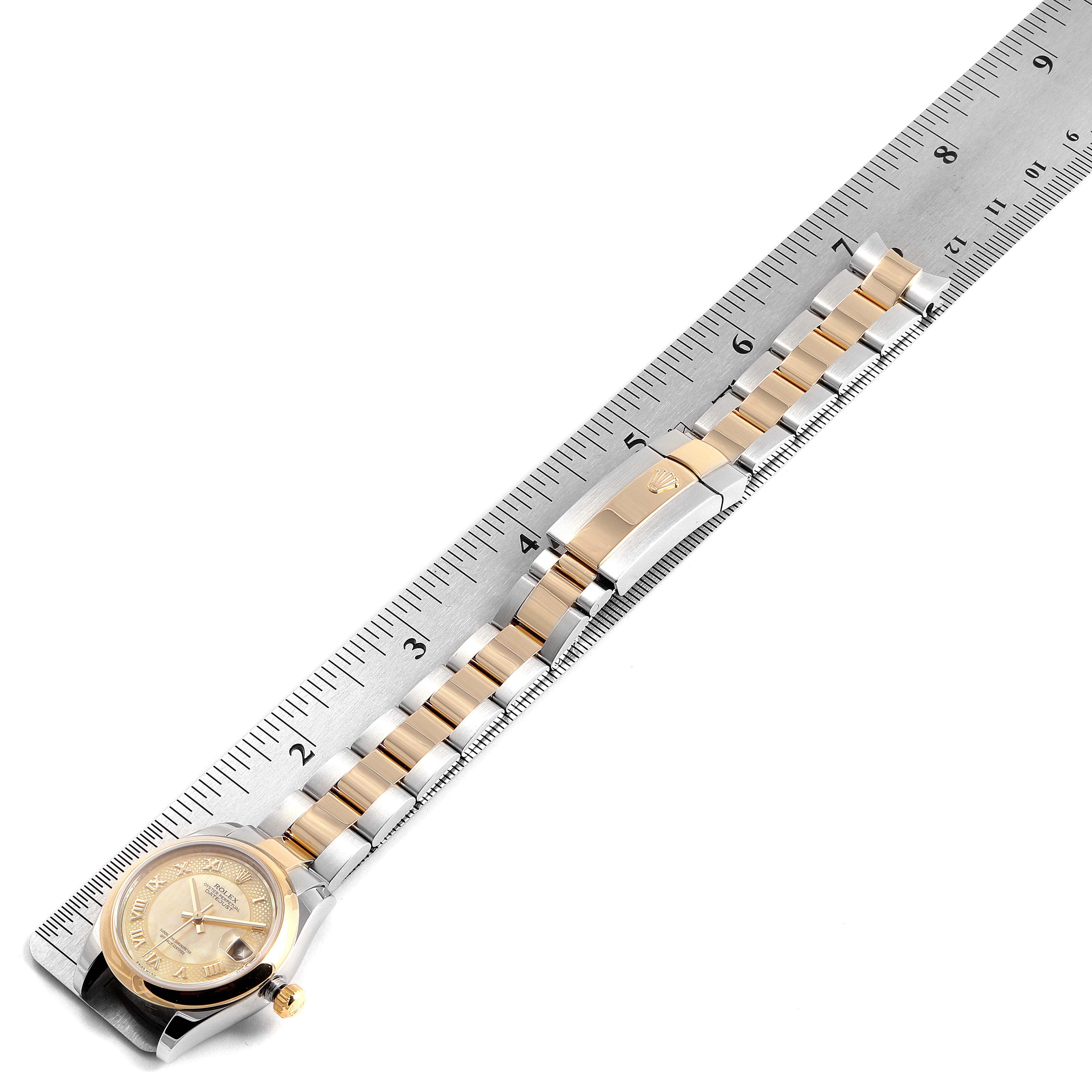 This image shows a top-down view of a Rolex Mid-Size 178243 Women's Steel and Gold (two tone) Mother of Pearl Dial 178243 Women's Steel and Gold (two tone) Mother of Pearl Dial watch with its band laid along a ruler for measurement.