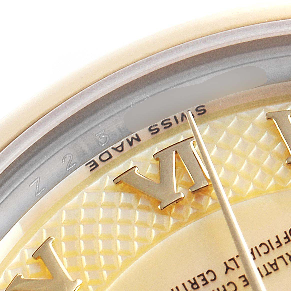 The image shows a close-up of the dial and part of the bezel of a Mid-Size Rolex watch, highlighting the "SWISS MADE" marking.