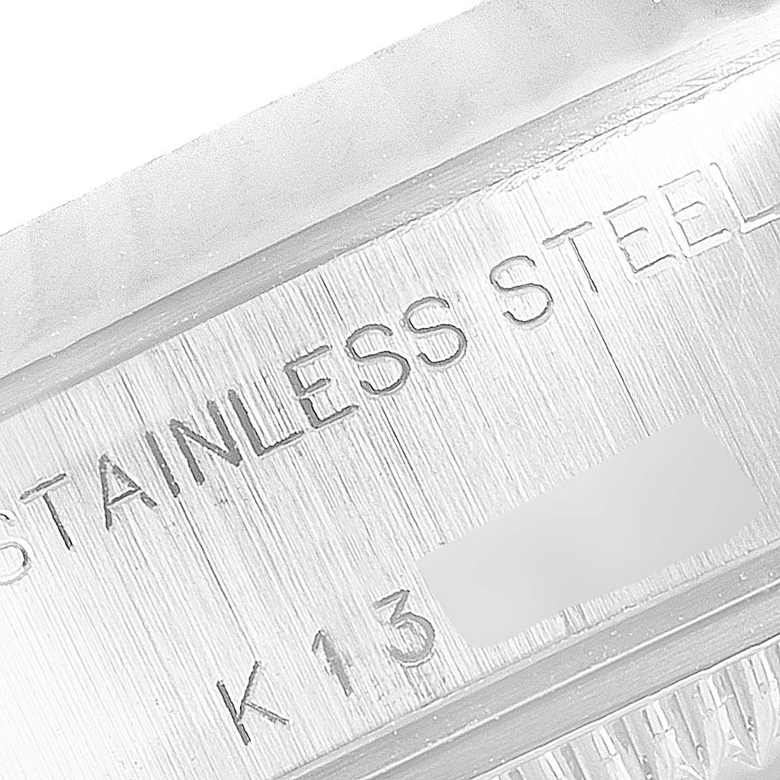 This close-up shows the engraved "STAINLESS STEEL" inscription on the case side of a Rolex Datejust 79174 Women's Stainless Steel Mother of Pearl Dial 79174 Women's Stainless Steel Mother of Pearl Dial watch.