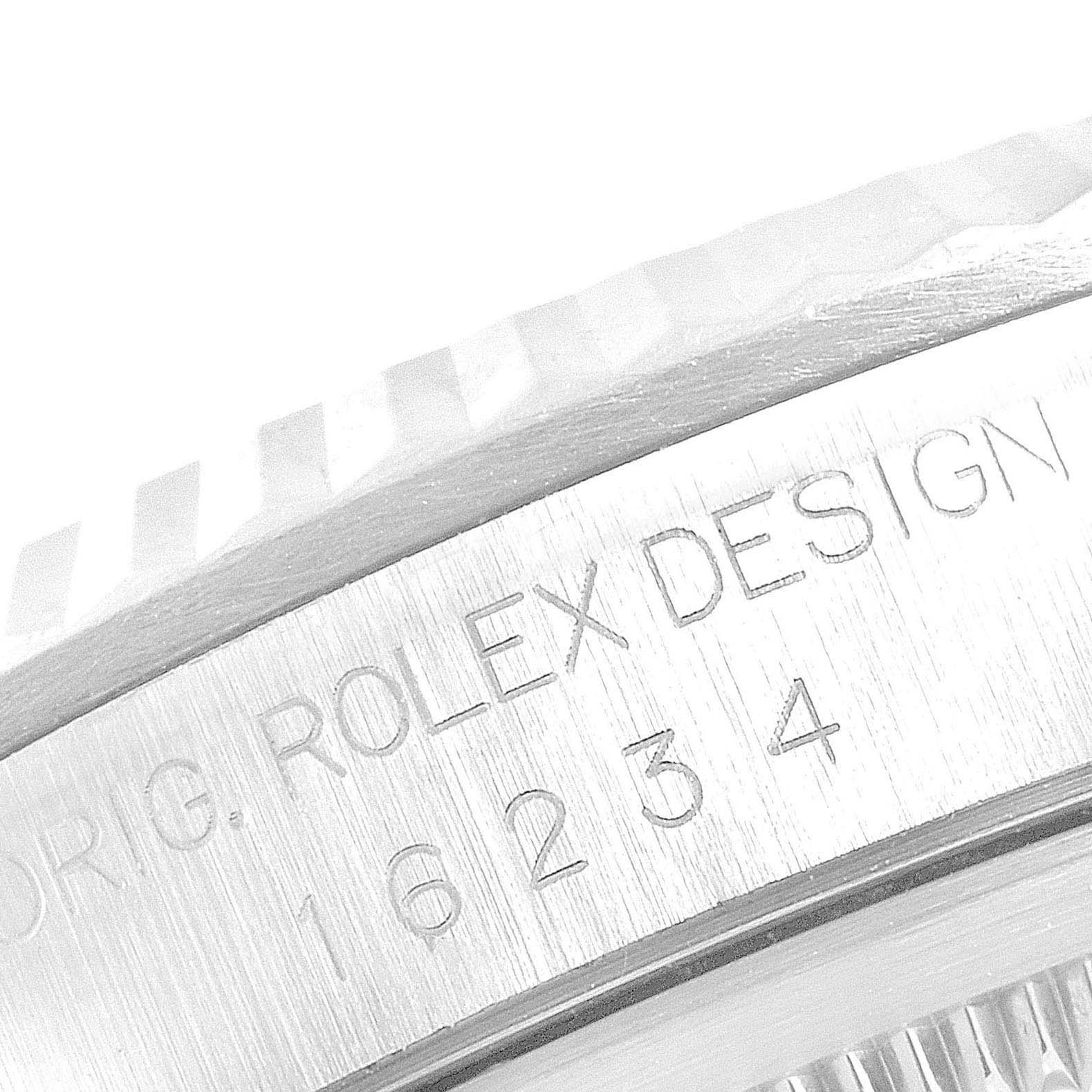 The image shows a close-up of the side of a Rolex Datejust 16234 Men's Stainless Steel Silver Dial 16234 Men's Stainless Steel Silver Dial watch, highlighting the engraved model information.