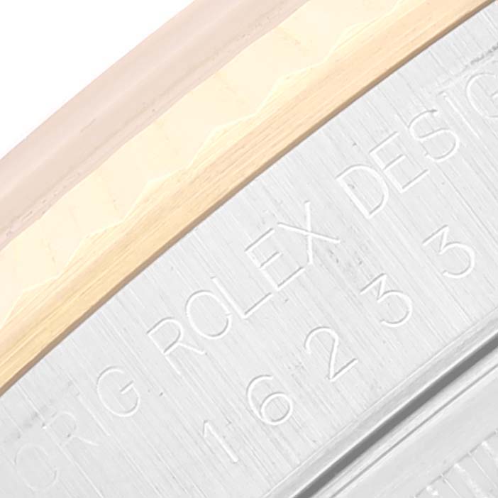 This close-up image shows the engraved bezel and part of the case of the Rolex Datejust 16233 Men's Steel and Gold (two tone) Champagne Dial 16233 Men's Steel and Gold (two tone) Champagne Dial watch.