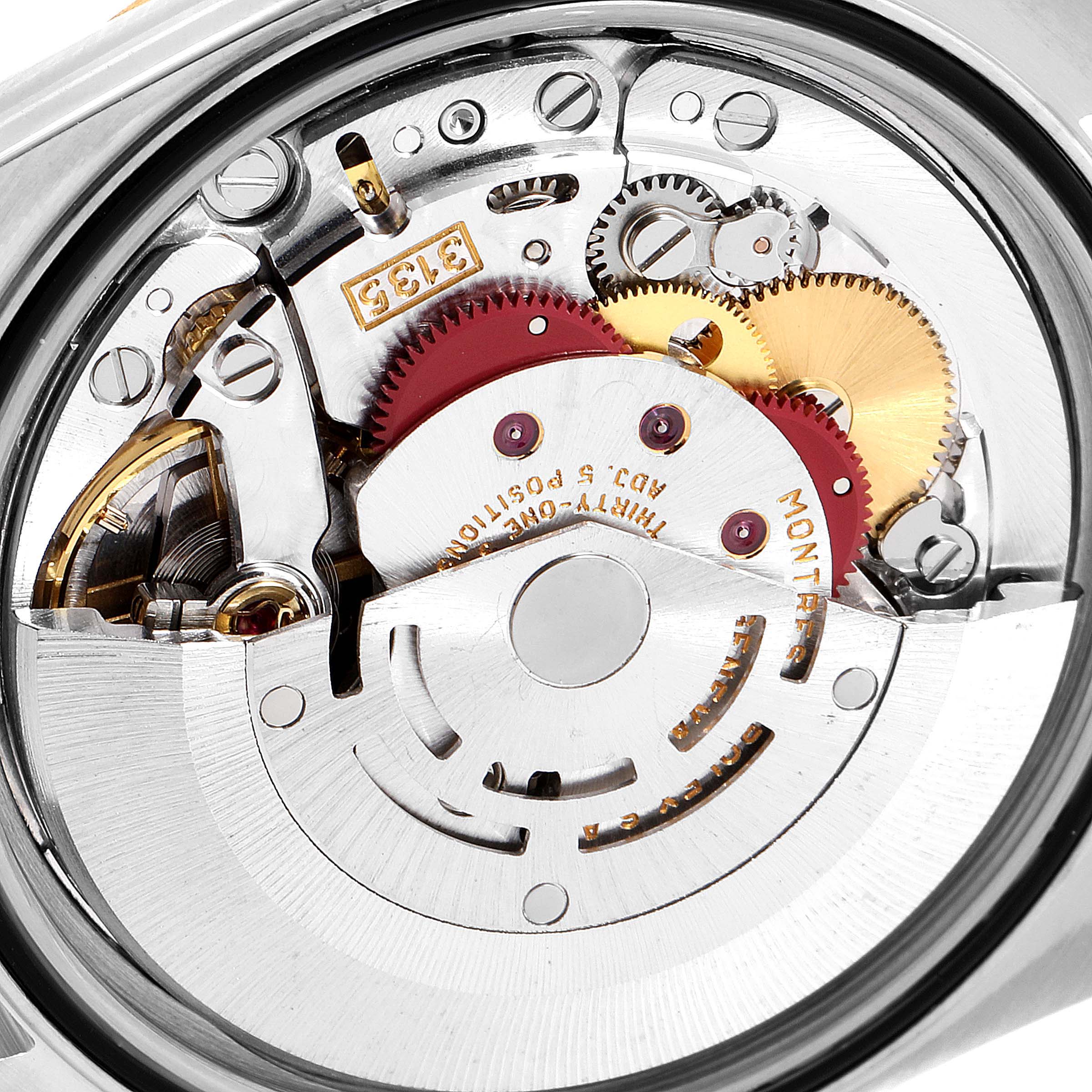 The image shows the internal mechanical movement of a Rolex Datejust 16233 Men's Steel and Gold (two tone) Champagne Dial 16233 Men's Steel and Gold (two tone) Champagne Dial watch, highlighting its gears and rotor from the back.