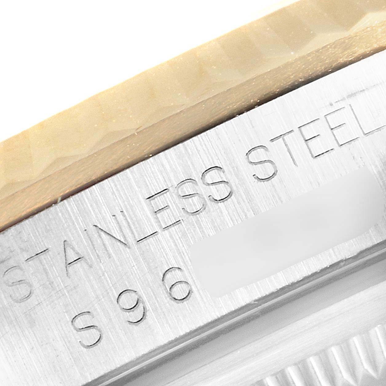 This image shows a close-up of the case and fluted bezel of a Rolex Datejust 16233 Men's Steel and Gold (two tone) Champagne Dial 16233 Men's Steel and Gold (two tone) Champagne Dial, displaying the "Stainless Steel" engraving.