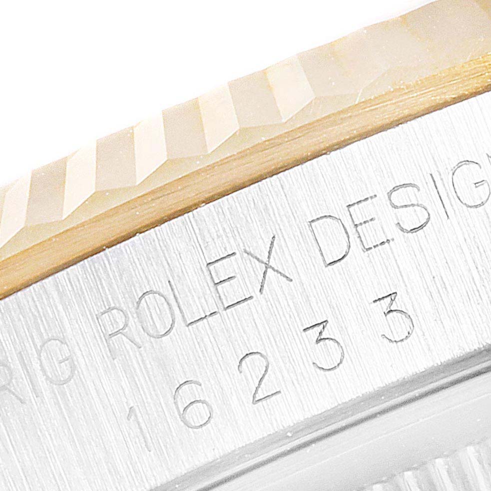 This close-up image shows the engraved side of the bezel and case of a Rolex Datejust 16233 Men's Steel and Gold (two tone) Champagne Dial 16233 Men's Steel and Gold (two tone) Champagne Dial watch.