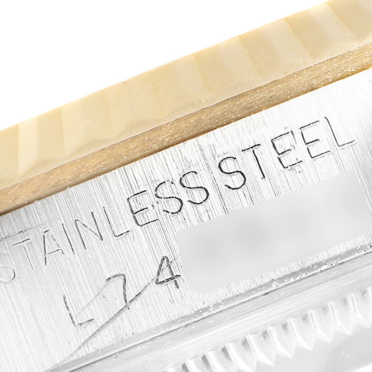 This image shows a close-up of the stainless steel casing and fluted bezel of a Rolex Datejust 16233 Men's Steel and Gold (two tone) Champagne Dial 16233 Men's Steel and Gold (two tone) Champagne Dial watch.