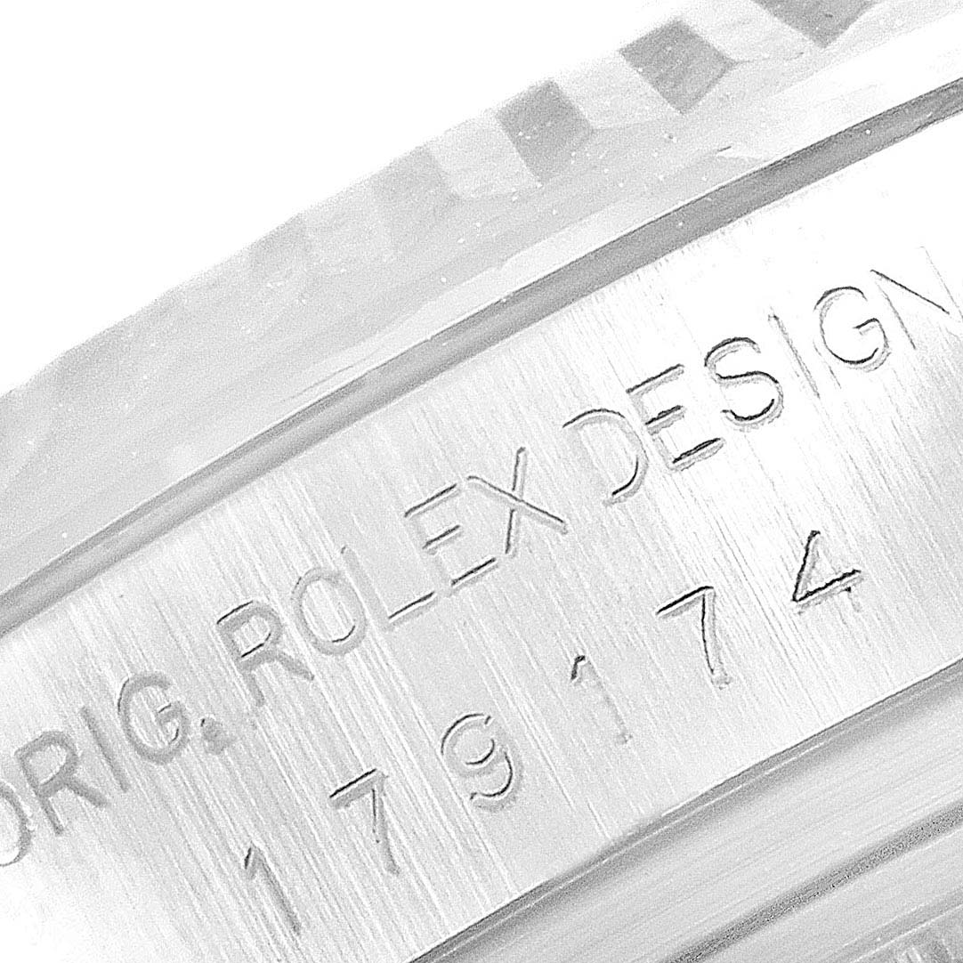 This image shows a close-up of the engraving on the side of a Rolex Datejust 179174  Women's Stainless Steel Silver Dial 179174  Women's Stainless Steel Silver Dial model watch.