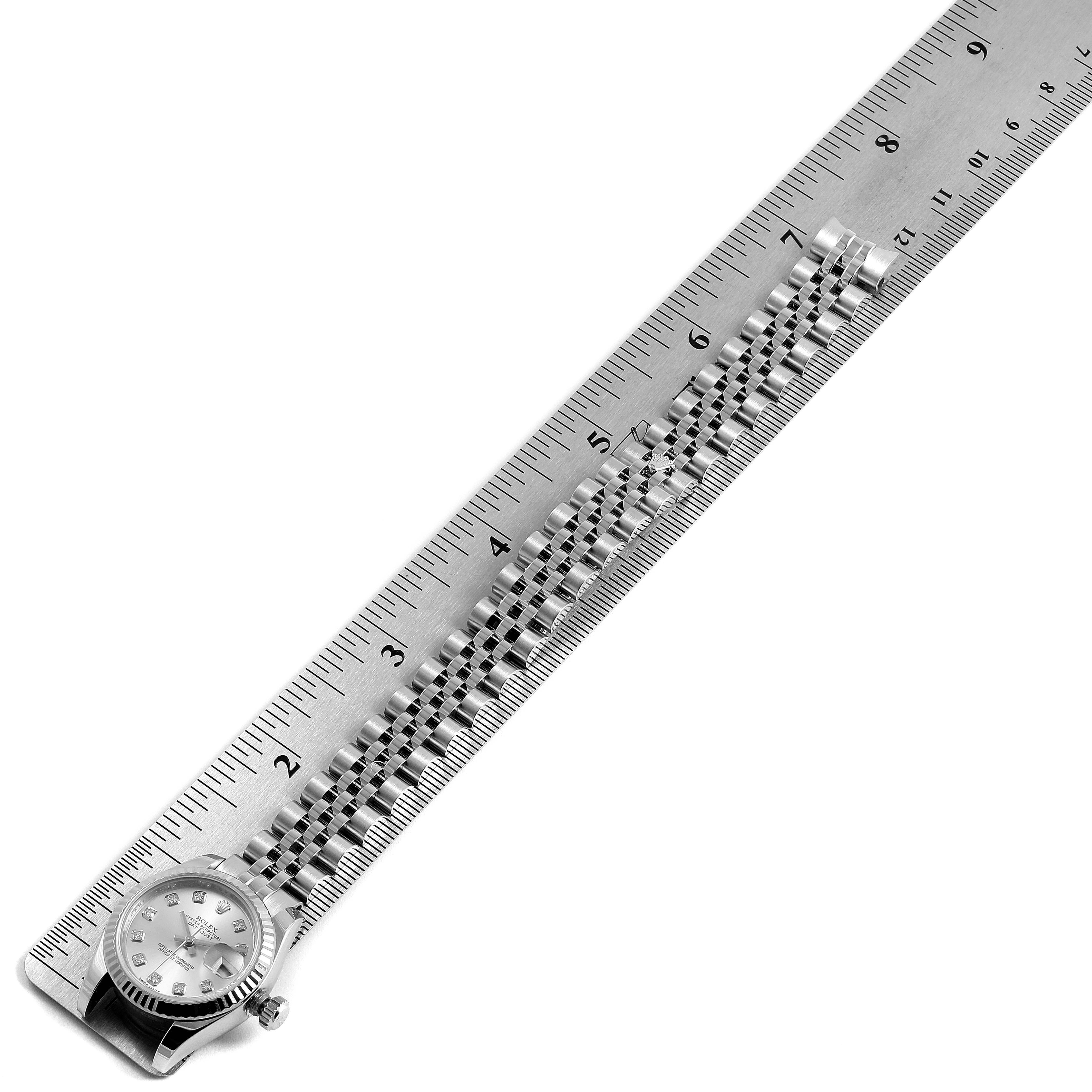 The image shows a top-down view of a Rolex Datejust 179174  Women's Stainless Steel Silver Dial 179174  Women's Stainless Steel Silver Dial watch with its bracelet aligned against a ruler for measurement.