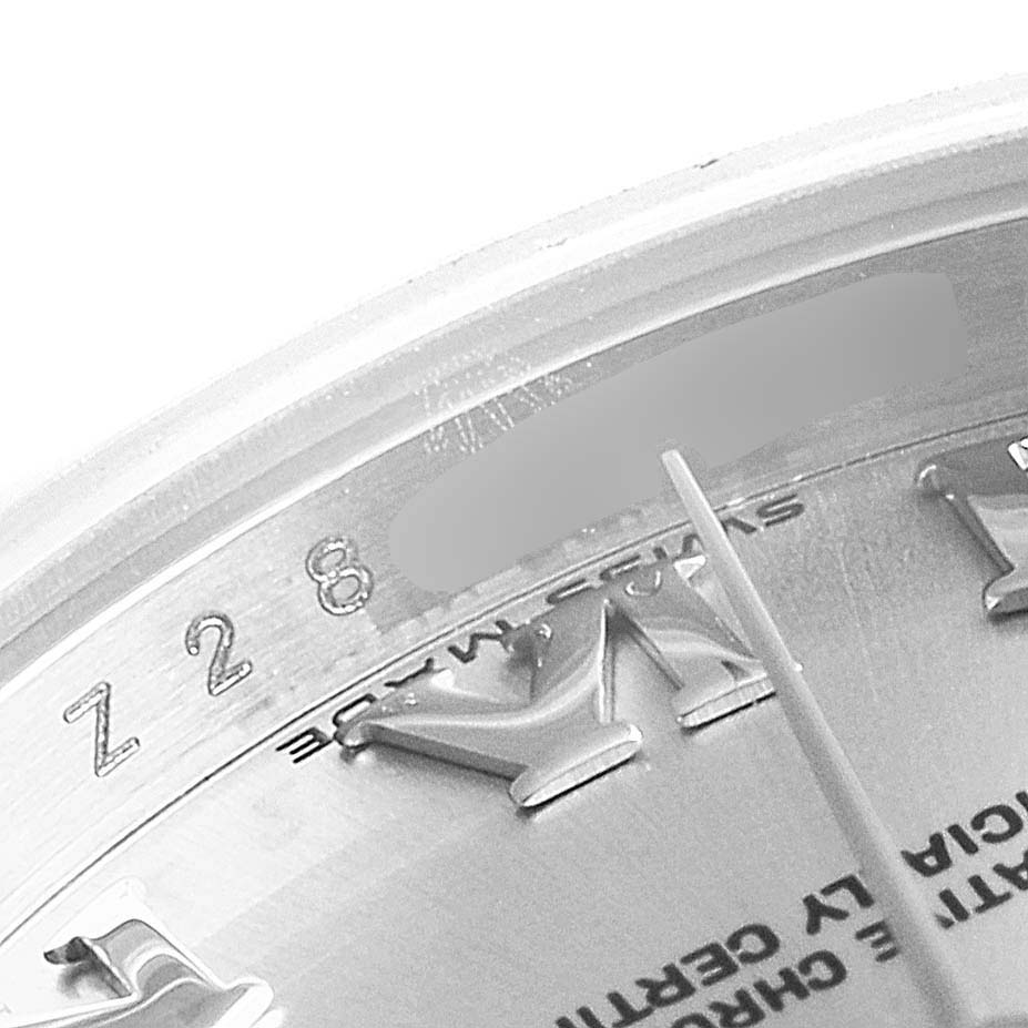 The image shows a close-up of a Rolex Datejust 179174 Women's Stainless Steel Grey Dial 179174 Women's Stainless Steel Grey Dial watch dial, featuring part of the bezel, indices, and hour hand.