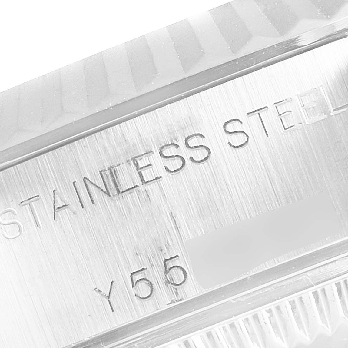 Close-up of the side of a Rolex Datejust 79174 Women's Stainless Steel Silver Dial 79174 Women's Stainless Steel Silver Dial watch, showing stainless steel engraving and part of the fluted bezel.