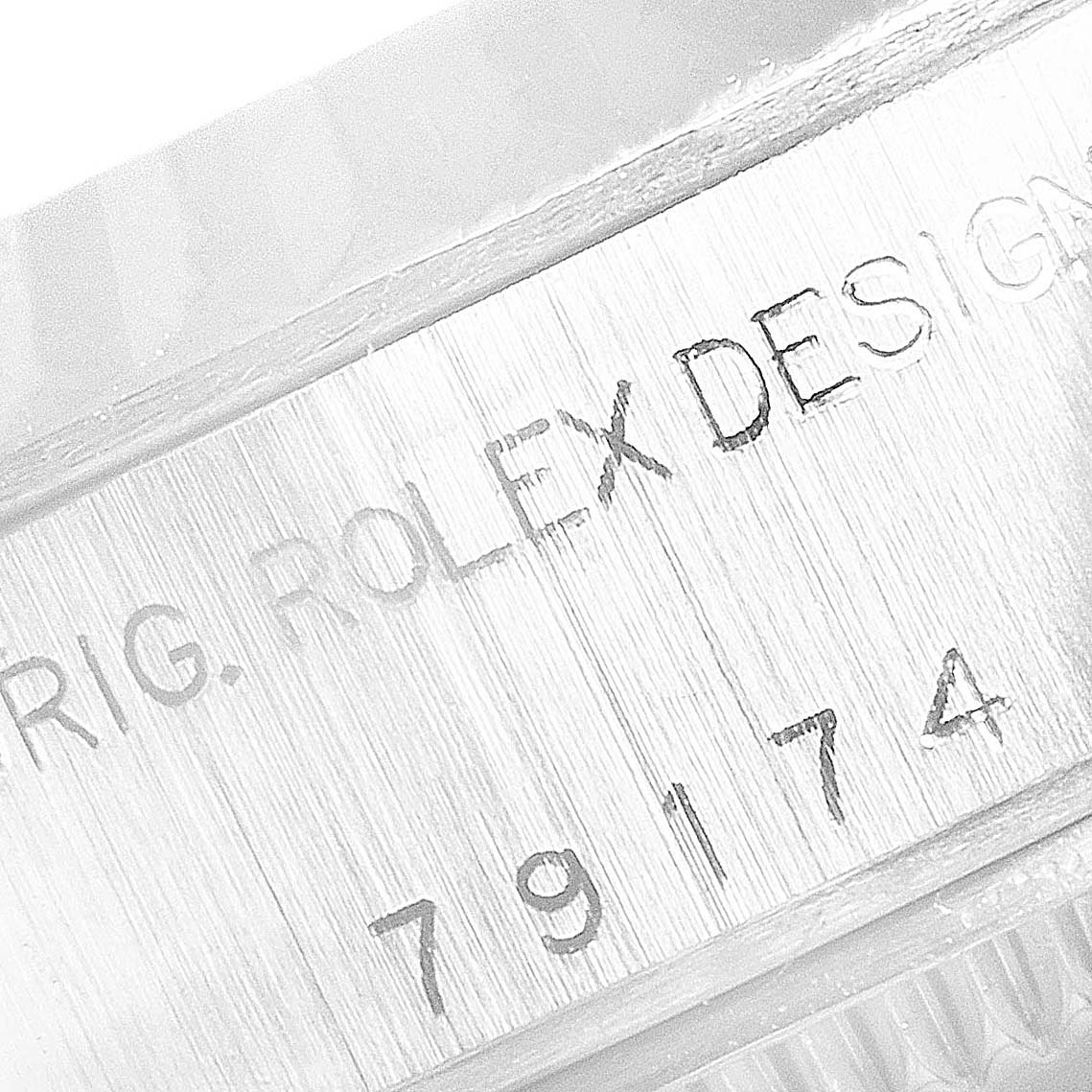 The image shows a close-up of the case side, featuring engraved text including "ORIG. ROLEX DESIGN" and the model number "79174" on a Rolex Datejust 79174 Women's Stainless Steel Silver Dial 79174 Women's Stainless Steel Silver Dial.