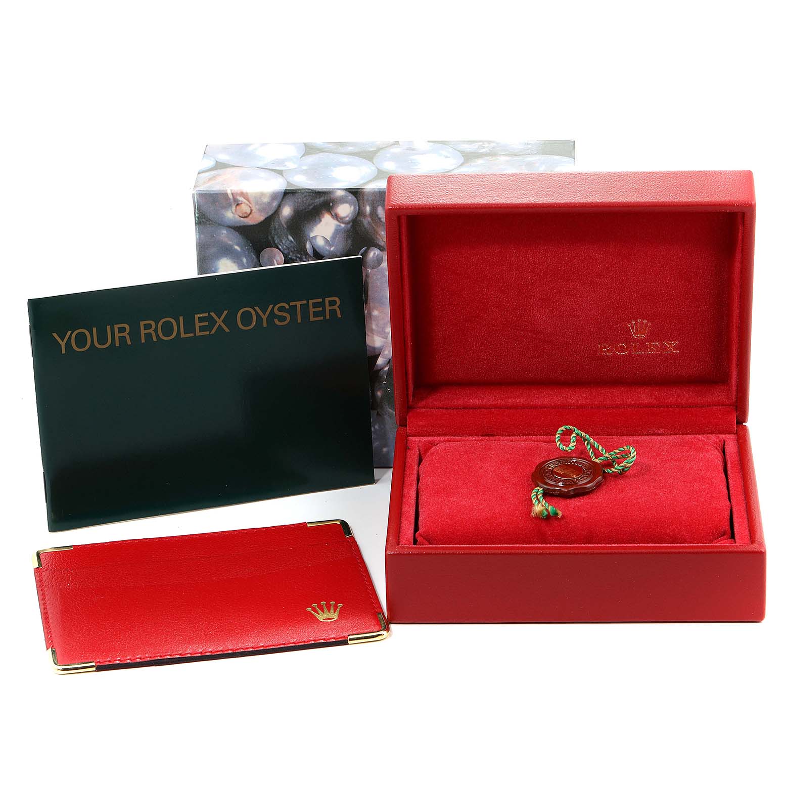 The image shows an open Rolex Datejust 69173 Women's Steel and Gold (two tone) Black Dial 69173 Women's Steel and Gold (two tone) Black Dial box set with a booklet, a cardholder, and a tag, viewed from the top.