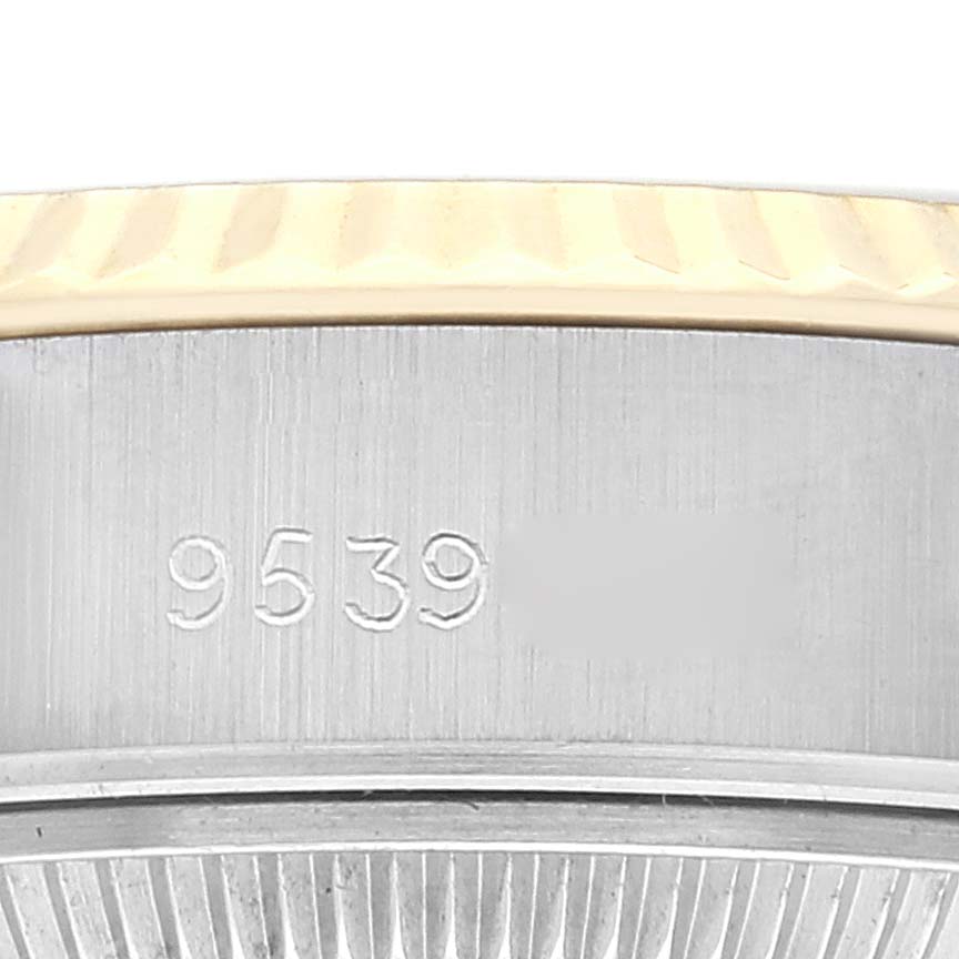 This image shows the side view focusing on the serial number engraved on the bezel of a Rolex Datejust 69173 Women's Steel and Gold (two tone) Champagne Dial 69173 Women's Steel and Gold (two tone) Champagne Dial model.