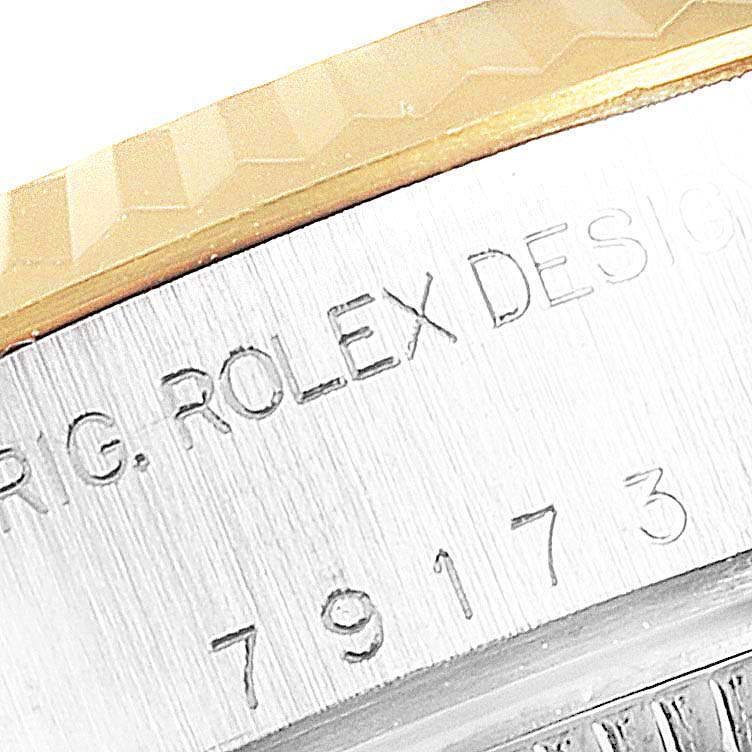 This close-up image shows the serial number and bezel of the Rolex Datejust 79173 Women's Stainless Steel Champagne Dial 79173 Women's Stainless Steel Champagne Dial watch.