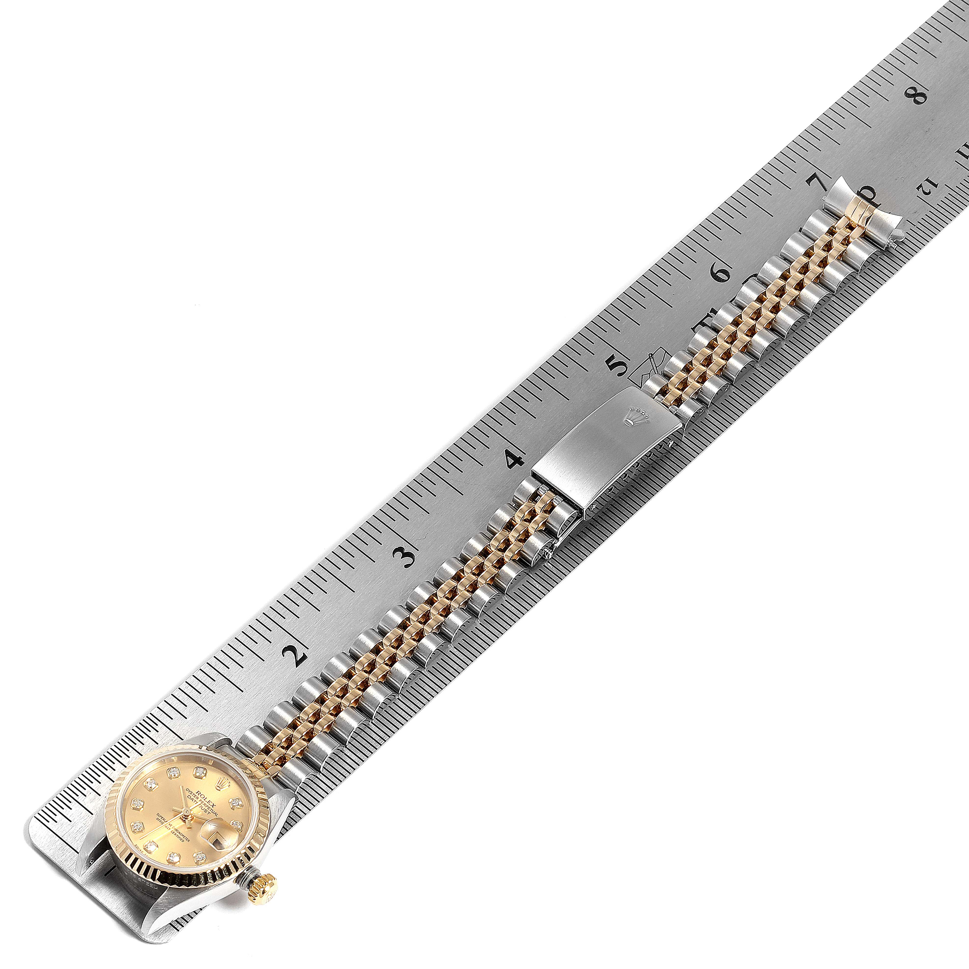The image shows a Rolex Datejust 79173 Women's Stainless Steel Champagne Dial 79173 Women's Stainless Steel Champagne Dial watch displayed horizontally alongside a ruler, highlighting the bracelet, clasp, and dial.