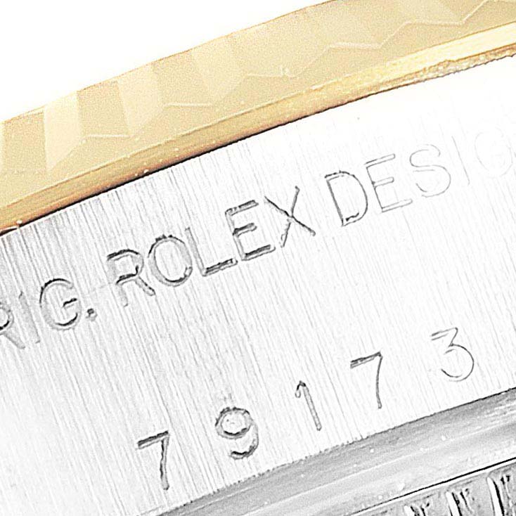 The image shows a close-up of the engraved serial number and "ROLEX DESIGN" text on the side of a Rolex Datejust 79173 Women's Stainless Steel Black Dial 79173 Women's Stainless Steel Black Dial watch.