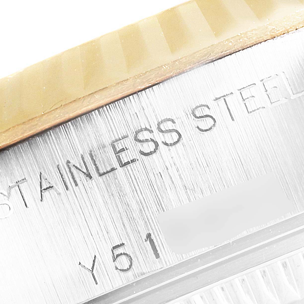 The image shows a close-up of the Rolex Datejust 79173 Women's Stainless Steel Black Dial 79173 Women's Stainless Steel Black Dial model, highlighting the fluted bezel and the engraved "STAINLESS STEEL" text on the case.