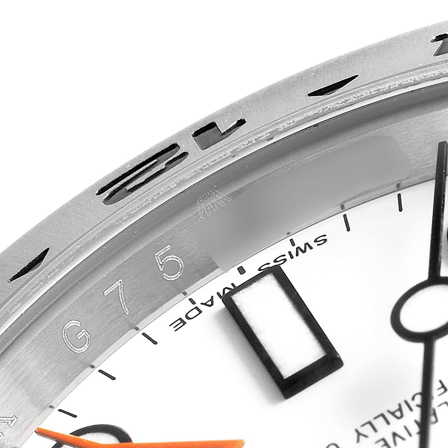 The image shows a close-up of the dial, bezel, and part of the orange hand of a Rolex Explorer 216570 Men's Stainless Steel White Dial 216570 Men's Stainless Steel White Dial watch.