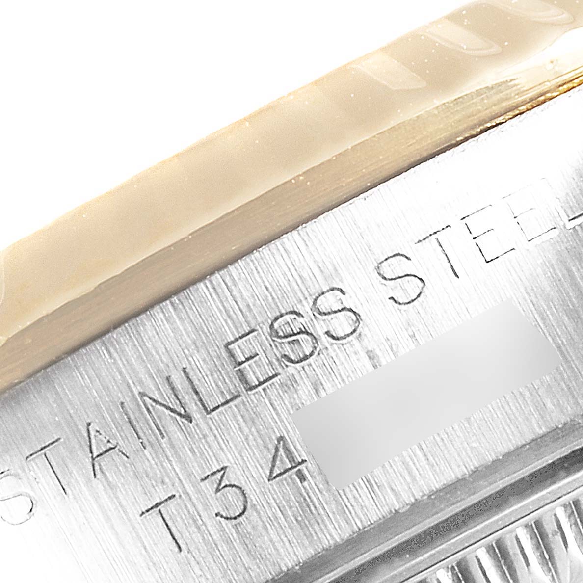 This close-up image shows the side engraving on the case of a Rolex Oyster Perpetual 67193 Women's Steel and Gold (two tone) Black Dial 67193 Women's Steel and Gold (two tone) Black Dial watch.