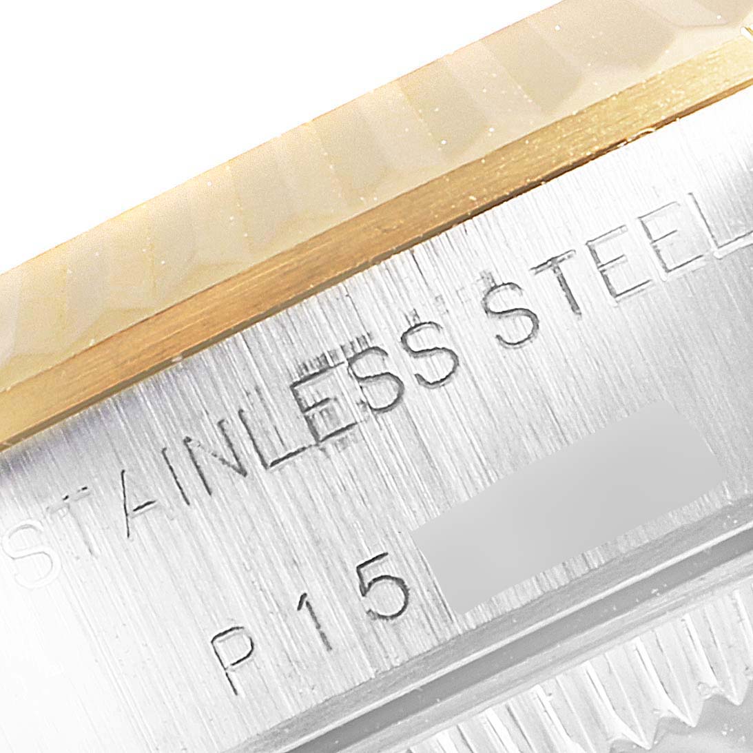 The image focuses on the side of a Rolex Oyster Perpetual 76193 Women's Steel and Gold (two tone) White Dial 76193 Women's Steel and Gold (two tone) White Dial watch, showing part of the bezel and engraved "STAINLESS STEEL."