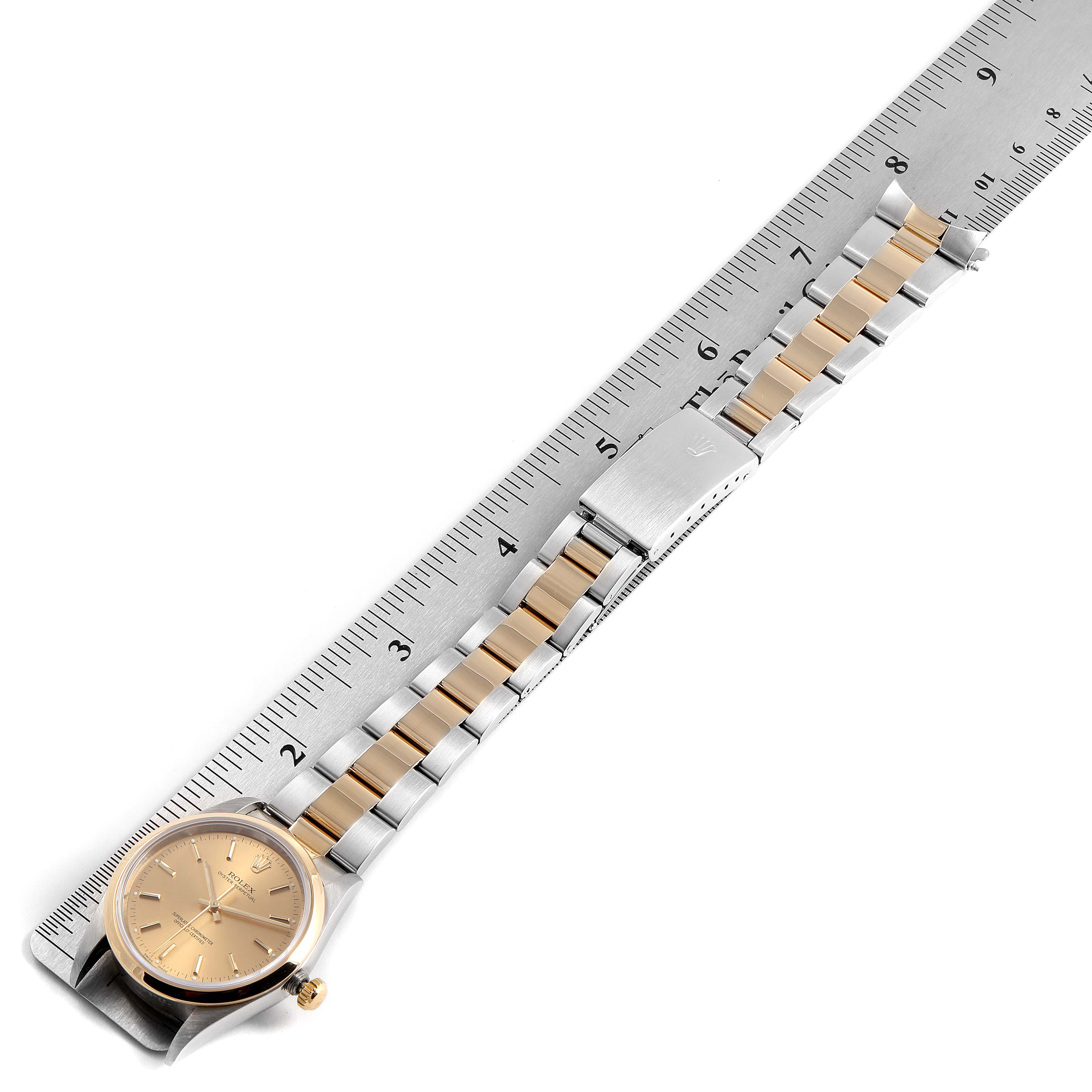 The image shows a Rolex Oyster Perpetual 14203 Men's Steel and Gold (two tone) Champagne Dial 14203 Men's Steel and Gold (two tone) Champagne Dial watch with its band and clasp fully extended, laid out beside a ruler for scale.