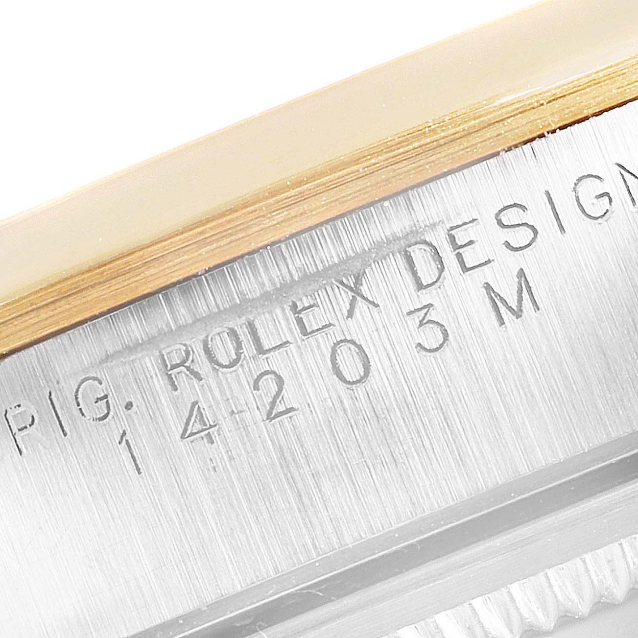 This image shows a close-up of the case side of a Rolex Oyster Perpetual 14203 Men's Steel and Gold (two tone) Champagne Dial 14203 Men's Steel and Gold (two tone) Champagne Dial watch, highlighting the engraved serial number and "Rolex Design" text.
