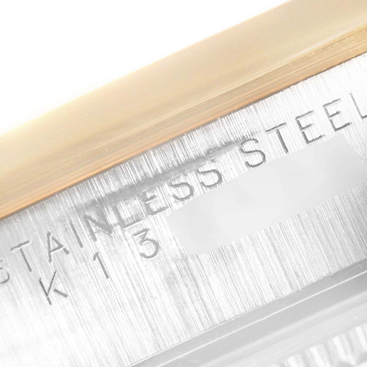 This image shows a close-up of the case side detailing for the Rolex Oyster Perpetual 14203 Men's Steel and Gold (two tone) Champagne Dial 14203 Men's Steel and Gold (two tone) Champagne Dial, highlighting the stainless steel material.