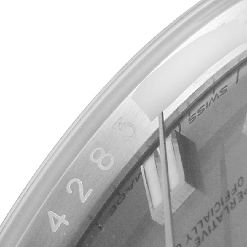 The image shows a close-up of the dial and bezel, highlighting numbers and the words "SWISS" from the Rolex Oyster Perpetual 116000 Men's Stainless Steel Grey Dial 116000 Men's Stainless Steel Grey Dial watch.