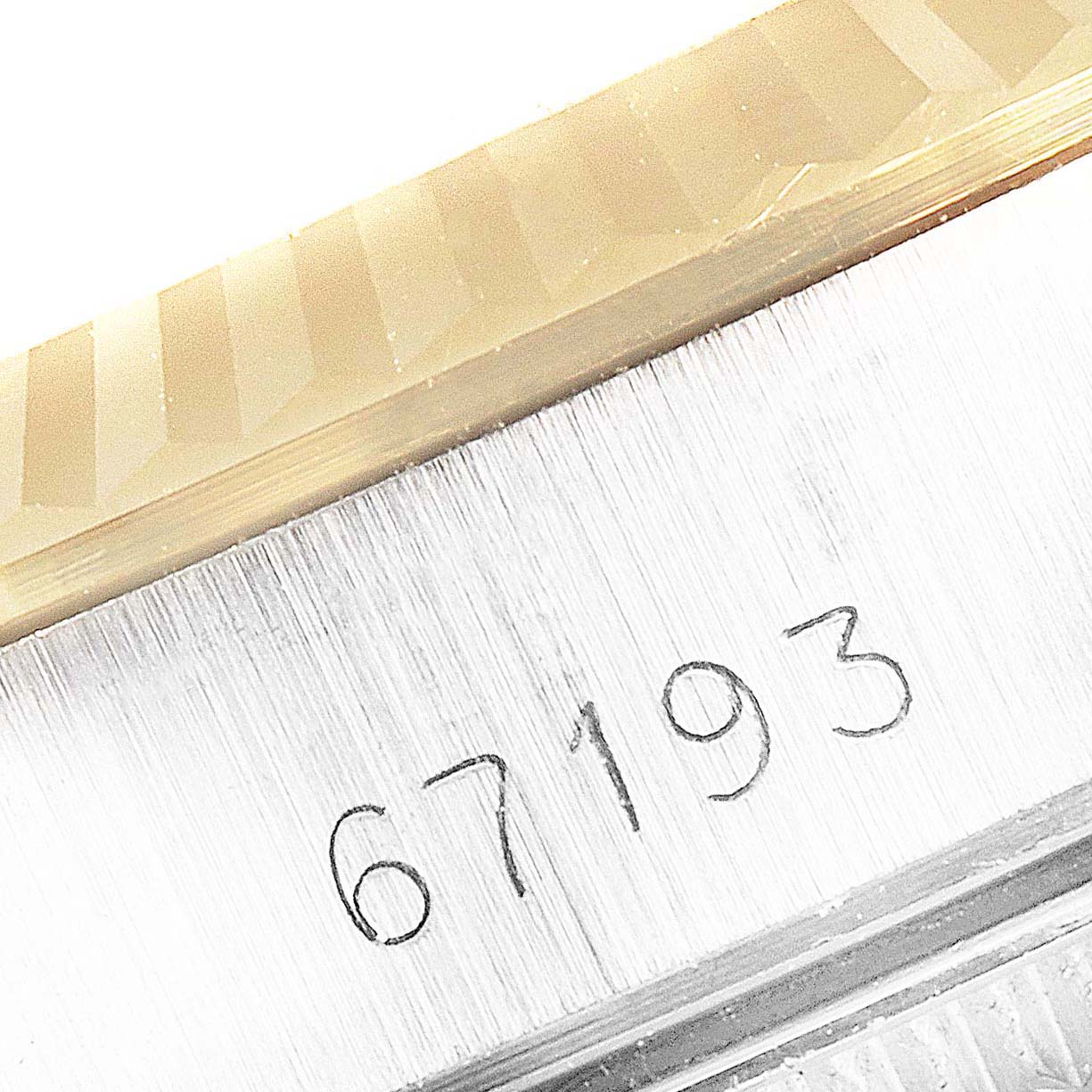 This image shows a close-up of the model number 67193 engraved on the case of a Rolex Datejust 67193 Women's Steel and Gold (two tone) White Dial 67193 Women's Steel and Gold (two tone) White Dial watch.