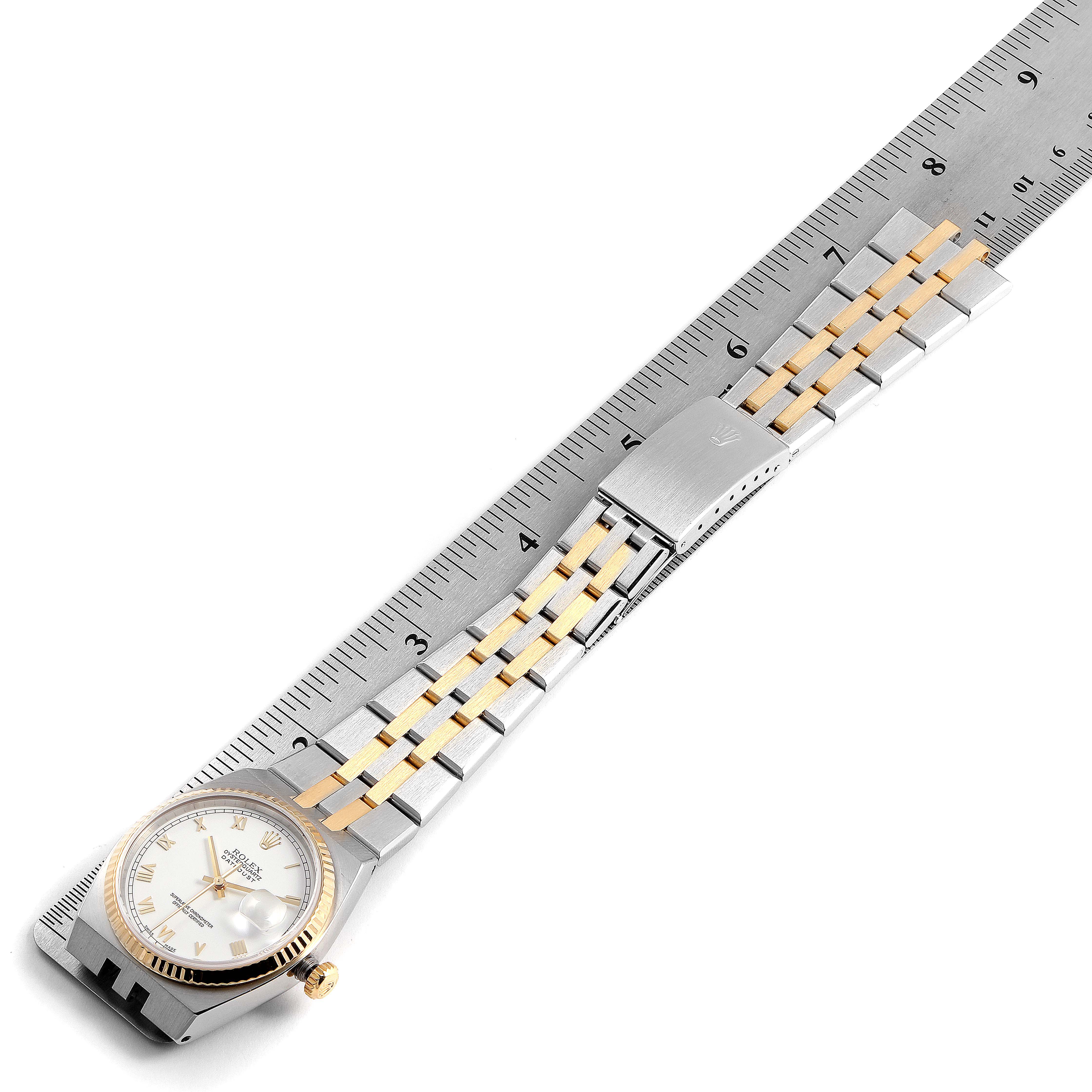 The image shows a Rolex Oysterquartz 16865 Men's Stainless Steel White Dial 16865 Men's Stainless Steel White Dial watch and a bracelet measured against a ruler from an overhead perspective.