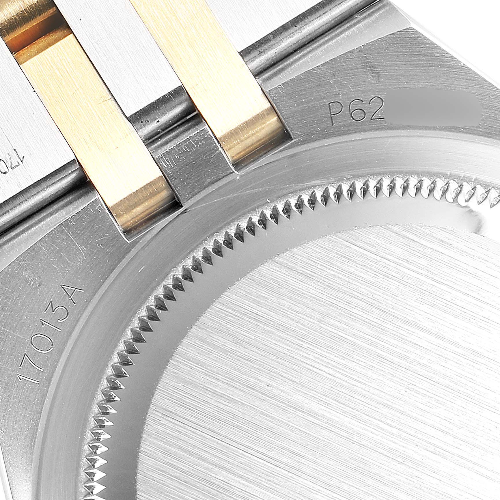 This image shows the back case and part of the bracelet of a Rolex Oysterquartz 16865 Men's Stainless Steel White Dial 16865 Men's Stainless Steel White Dial watch, including the model number.