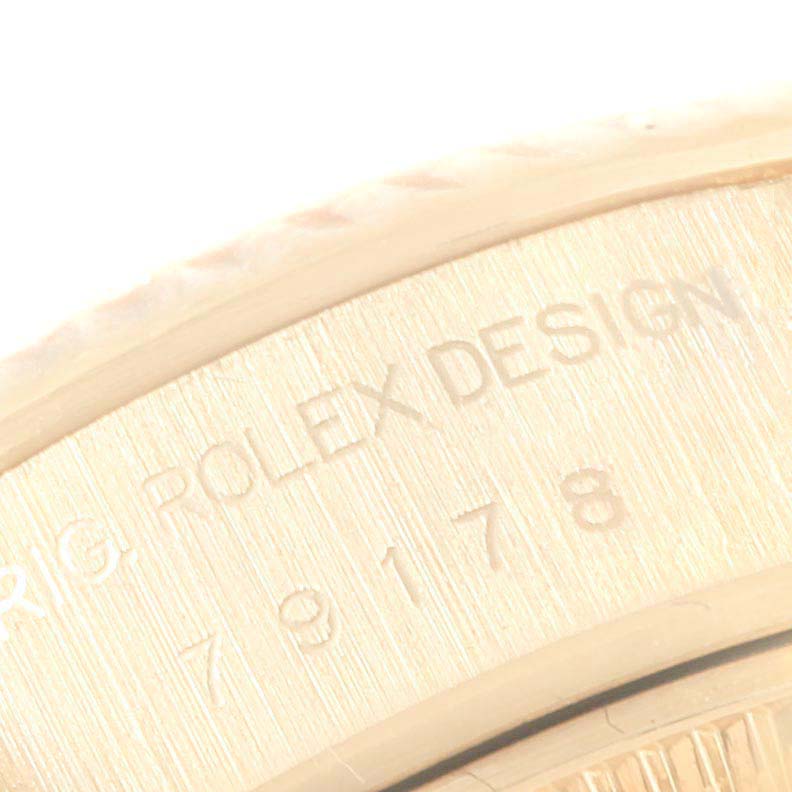 This image shows an engraved part of the bezel on a Rolex President 79178 Women
s Yellow Gold Champagne Dial 79178 Women
s Yellow Gold Champagne Dial model watch.