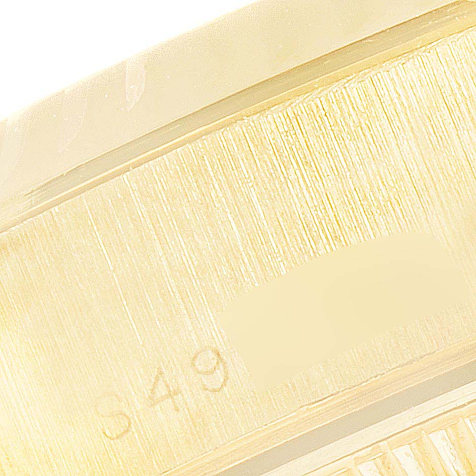 This close-up image shows part of the outer and inner ring of a Rolex President 69178 Women's Yellow Gold Champagne Dial 69178 Women's Yellow Gold Champagne Dial model watch.