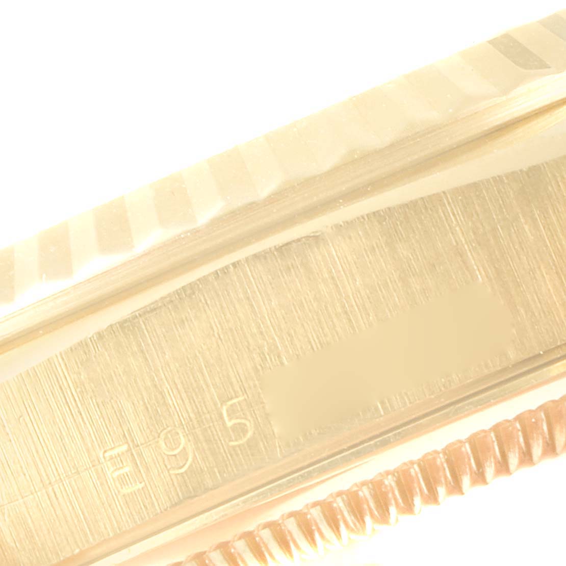 This close-up image shows the detailed engraving on the side of a Rolex President 18238 Men
s Yellow Gold Black Dial 18238 Men
s Yellow Gold Black Dial model watch case.