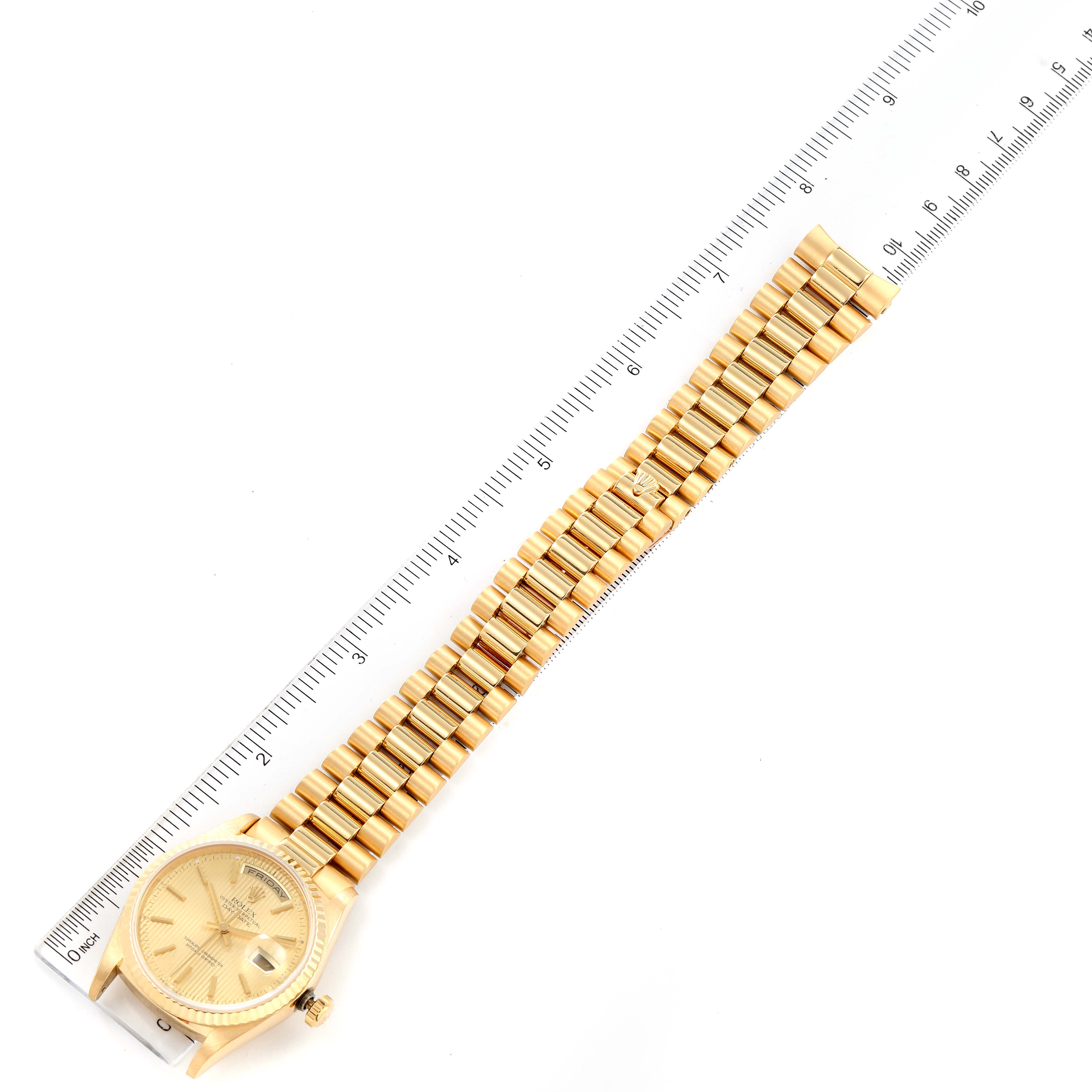 The image shows the Rolex President 18238 Men
s Yellow Gold Champagne Dial 18238 Men
s Yellow Gold Champagne Dial model watch laid flat with a ruler beside it for measurement.