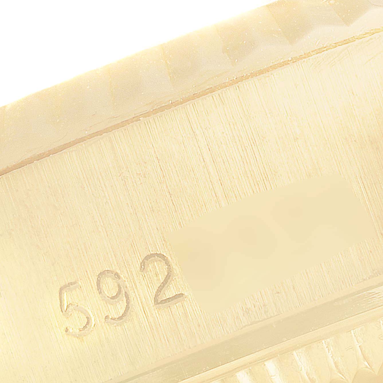 The image shows a close-up angle of the Rolex President 6917 Women's Yellow Gold Blue Dial 6917 Women's Yellow Gold Blue Dial model watch engraved with the number "592".