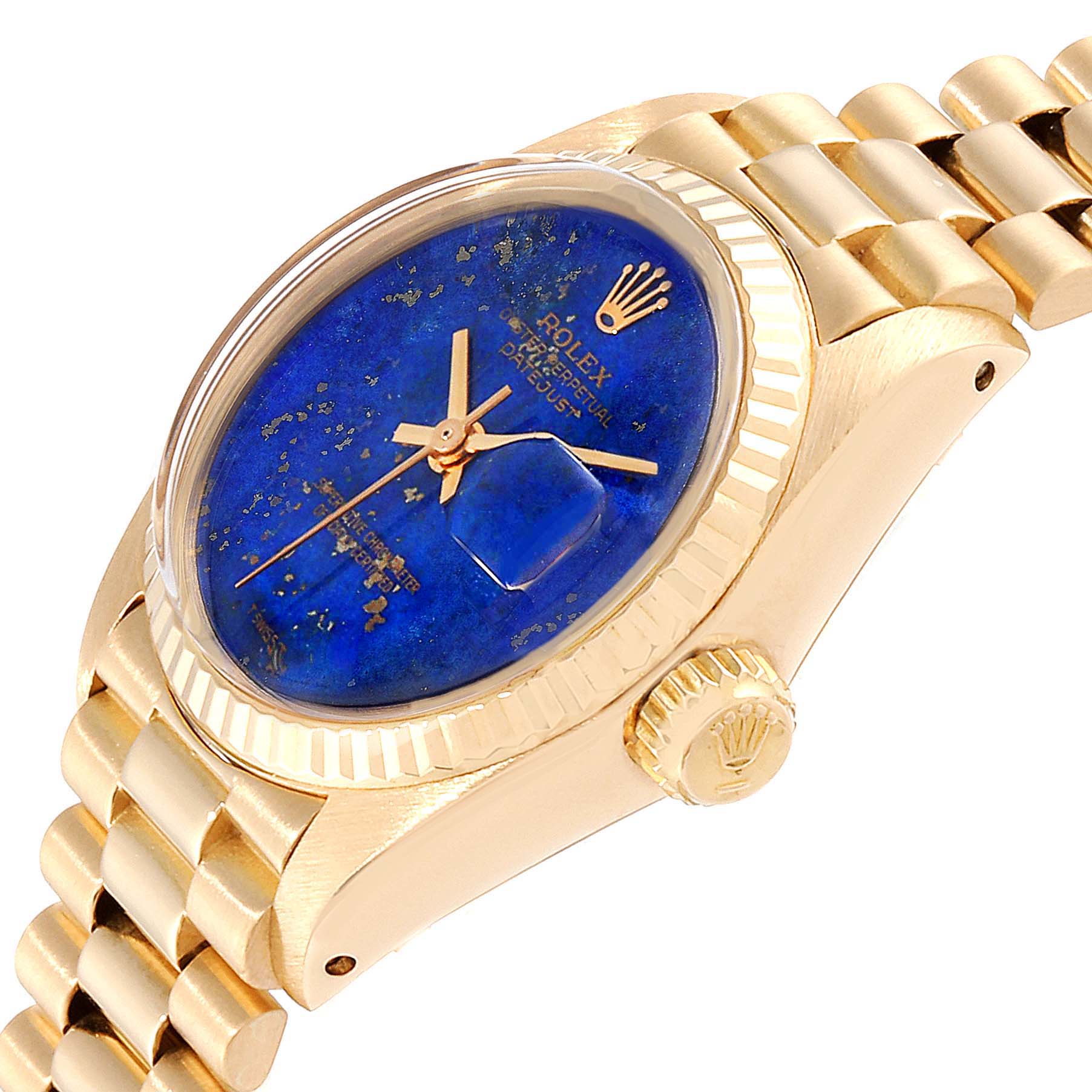 The image shows a side angle of a Rolex President 6917 Women's Yellow Gold Blue Dial 6917 Women's Yellow Gold Blue Dial model watch, featuring the dial, crown, and part of the bracelet.