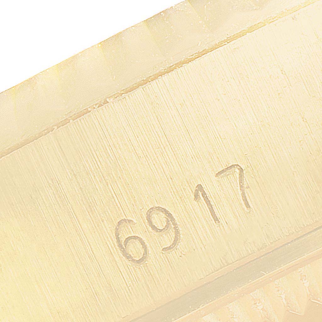 This close-up image shows the engraved reference number on the case of a Rolex President 6917 Women's Yellow Gold Blue Dial 6917 Women's Yellow Gold Blue Dial model watch.