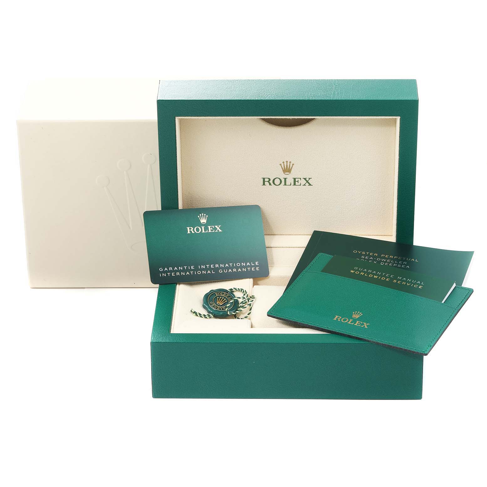 The image shows the open box of a Rolex Sea-Dweller 126660 Men
s Stainless Steel Blue Dial 126660 Men
s Stainless Steel Blue Dial watch with warranty card, manuals, and a tag.
