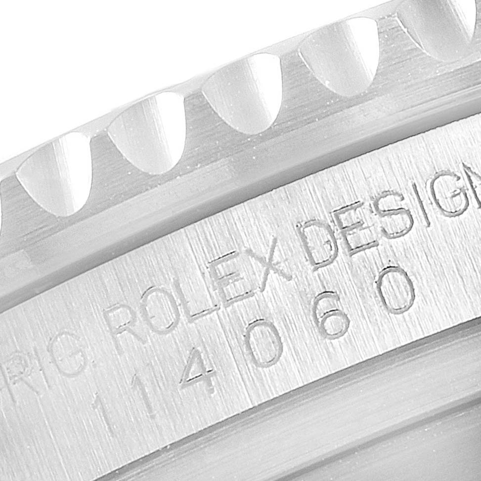 The image shows a close-up of the bezel and engraved serial number on a Rolex Submariner 114060 Men
s Stainless Steel Black Dial 114060 Men
s Stainless Steel Black Dial watch.