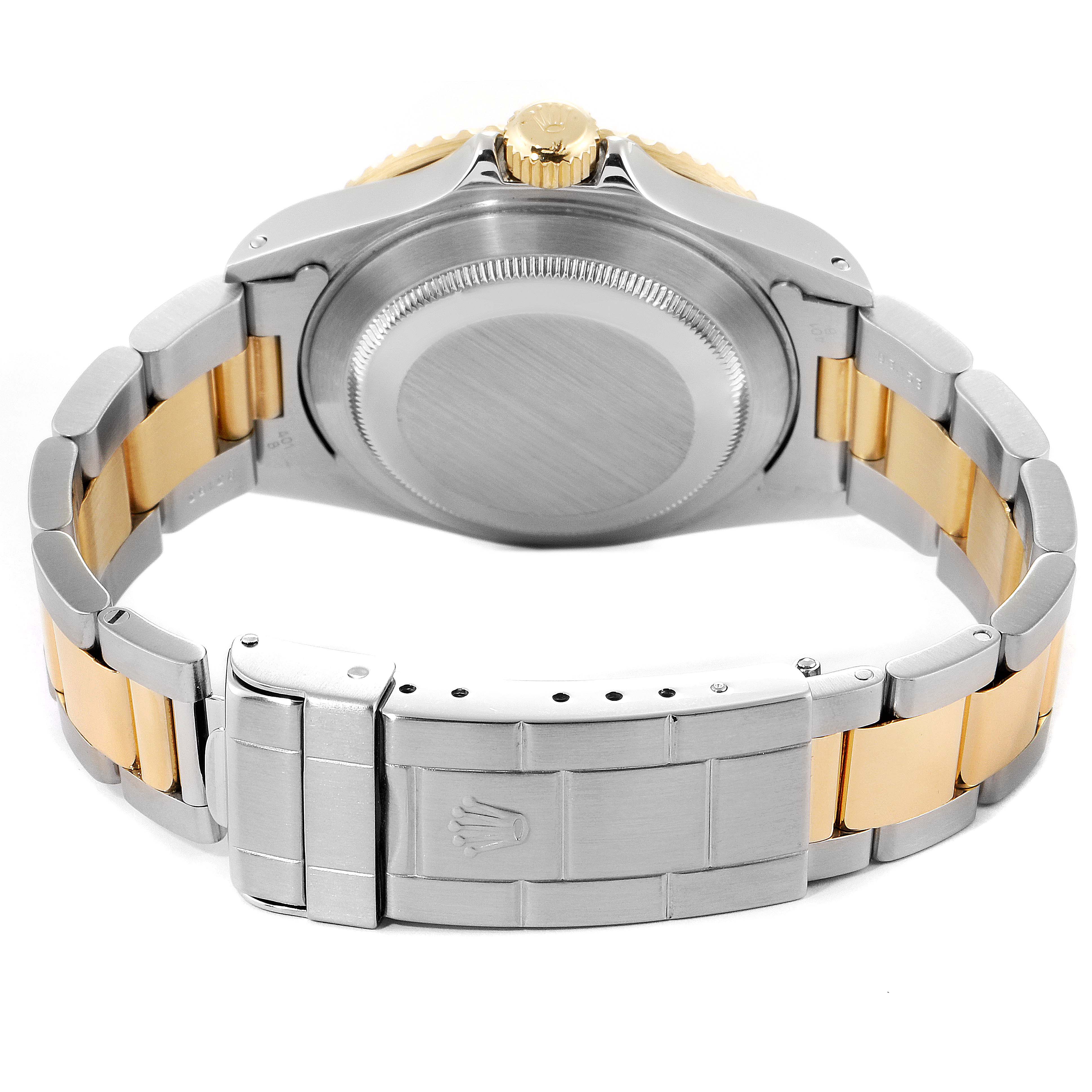 This image shows the back and bracelet of a Rolex Submariner 16613 Men's Steel and Gold (two tone) Blue Dial 16613 Men's Steel and Gold (two tone) Blue Dial, highlighting the case back and metal links.