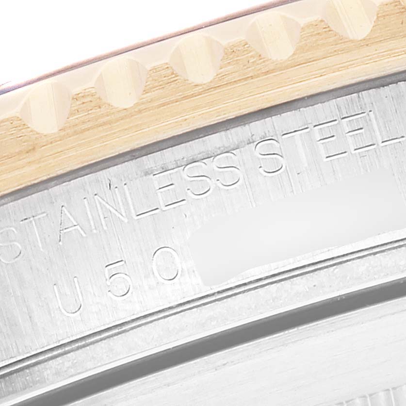 Close-up of the case back edge and part of the bezel of a Rolex Submariner 16613 Men's Steel and Gold (two tone) Blue Dial 16613 Men's Steel and Gold (two tone) Blue Dial, showing "STAINLESS STEEL" engraving.