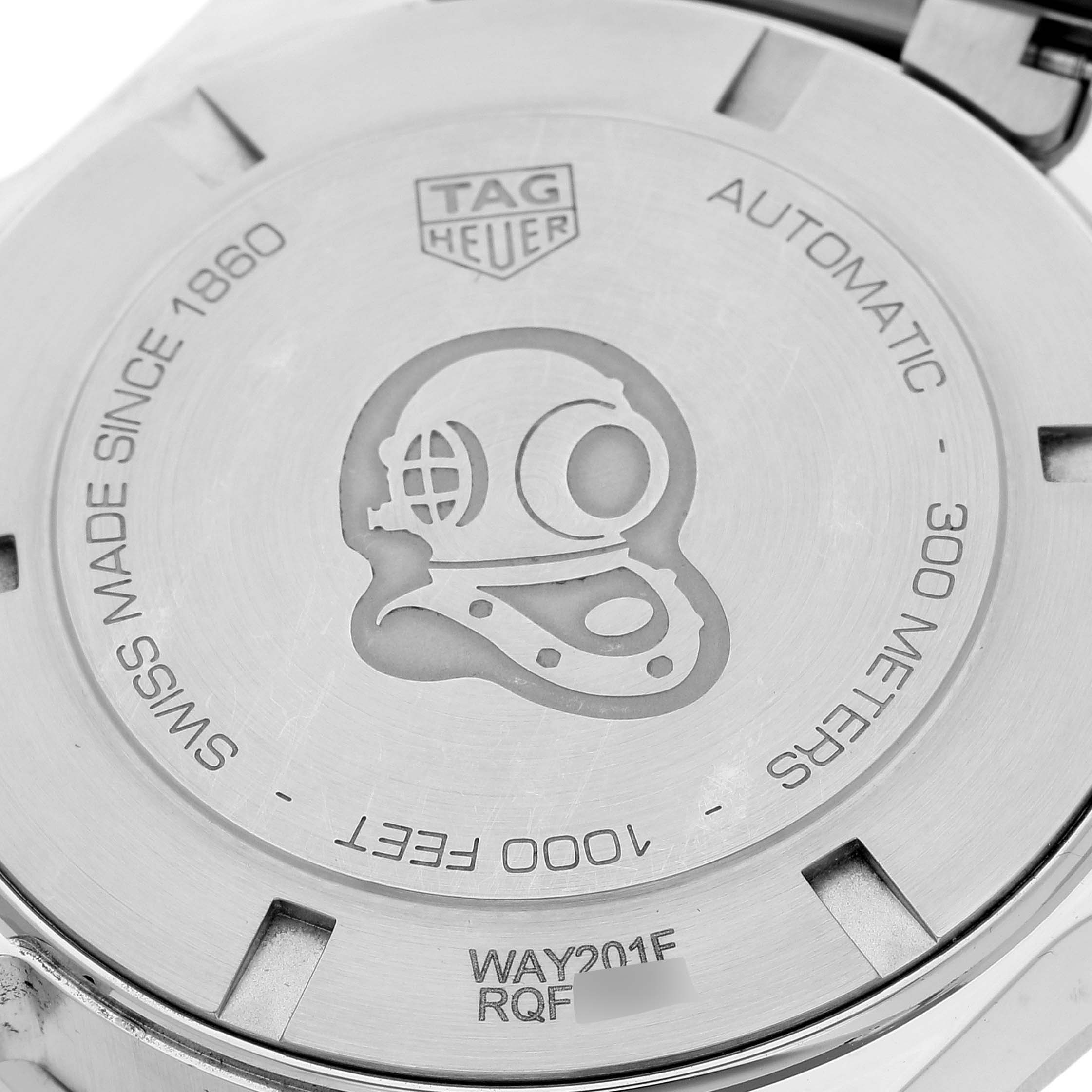 The image shows the case back of the Tag Heuer Aquaracer WAY201F Men's Stainless Steel Black Dial WAY201F Men's Stainless Steel Black Dial watch, featuring engravings and the brand logo.