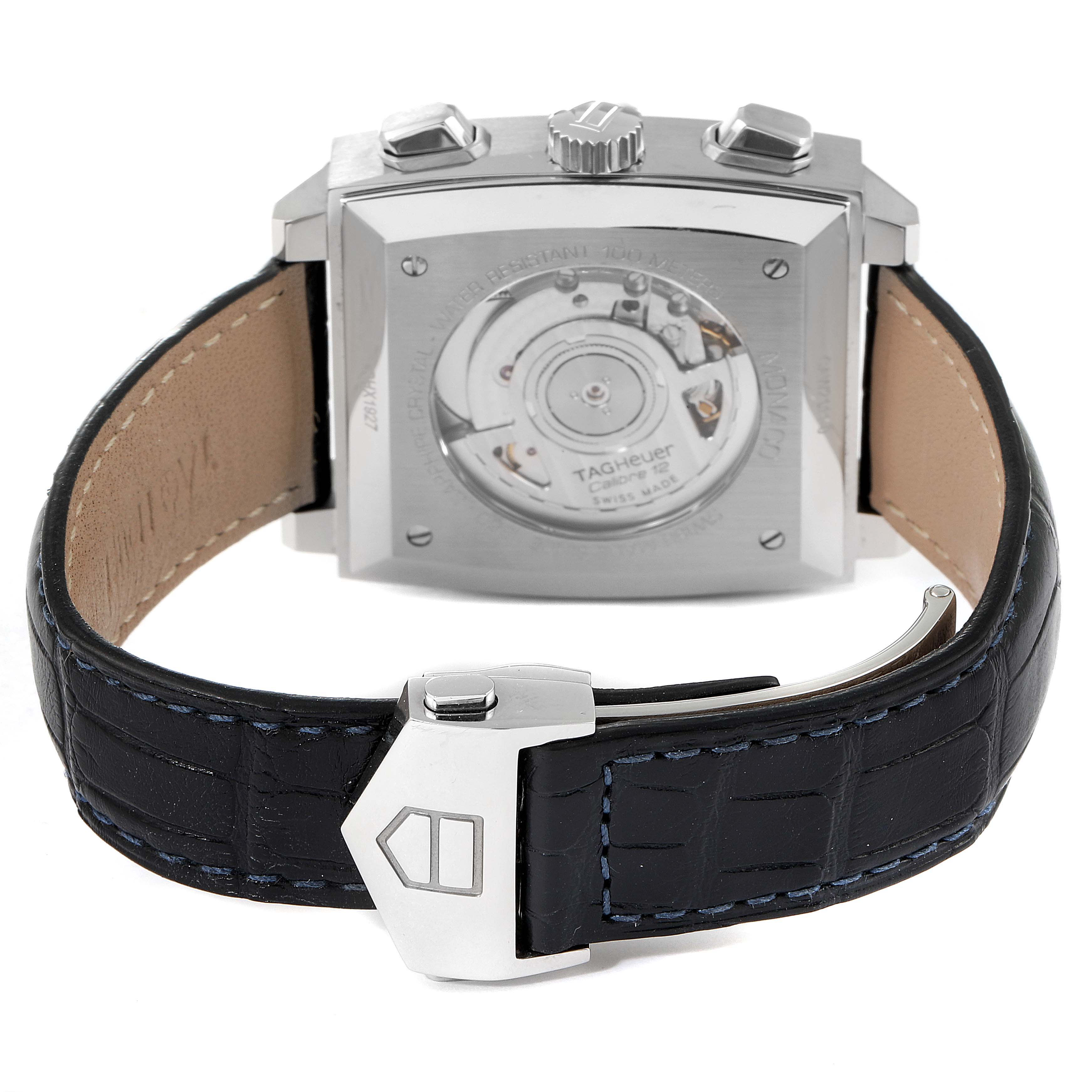 The image shows the Tag Heuer Monaco CAW2111 Men's Stainless Steel Blue Dial CAW2111 Men's Stainless Steel Blue Dial's back case and its strap, featuring the movement and deployment clasp.