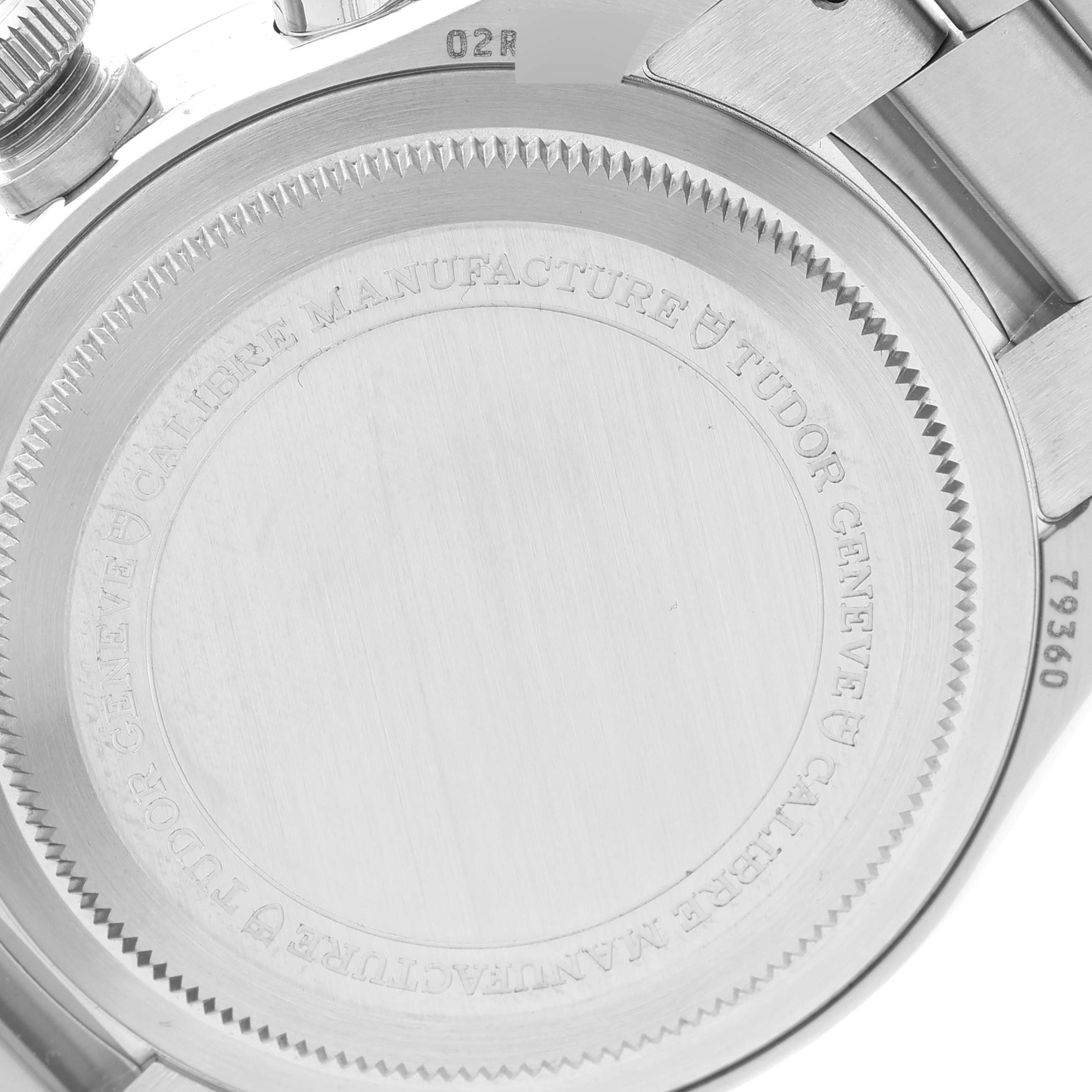 The image shows the back case of a Tudor Heritage Black Bay M79360N-0002 Men's Stainless Steel White Dial M79360N-0002 Men's Stainless Steel White Dial watch with engravings and partial bracelet.