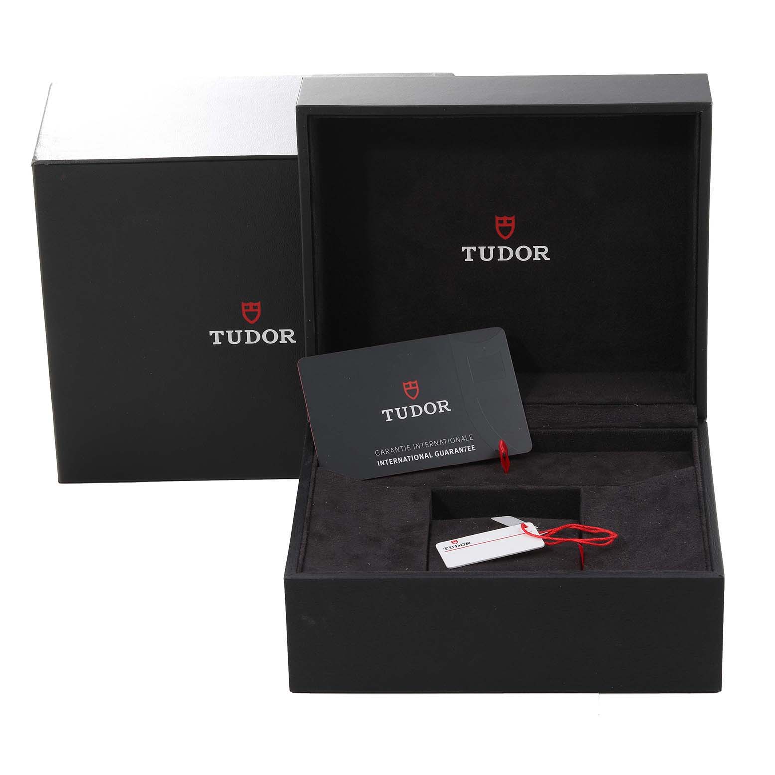The image shows the open box and warranty card for the Tudor Heritage Black Bay 79830RB Men
s Stainless Steel Black Dial 79830RB Men
s Stainless Steel Black Dial watch.