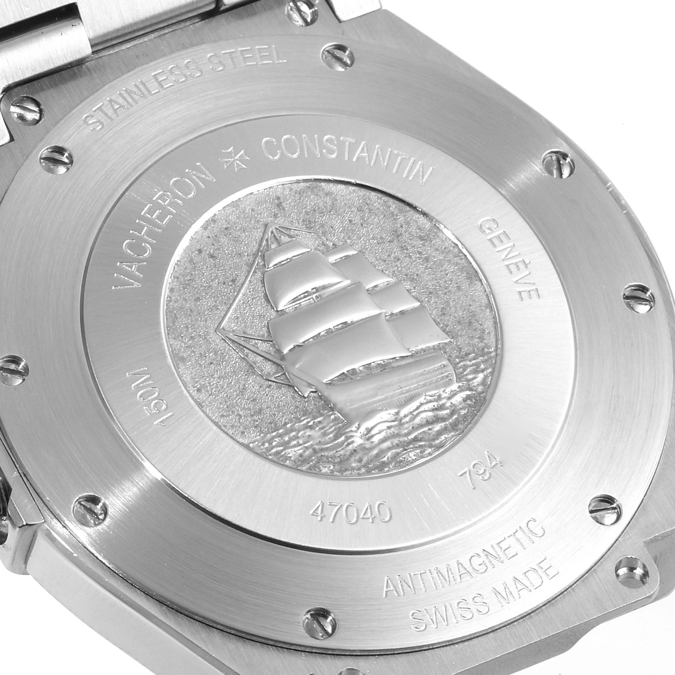 The image shows the case back of a Vacheron Constantin Overseas 47040B01A-9093 Men
s Stainless Steel Silver Dial 47040B01A-9093 Men
s Stainless Steel Silver Dial model watch, highlighting its engravings and embossed ship design.
