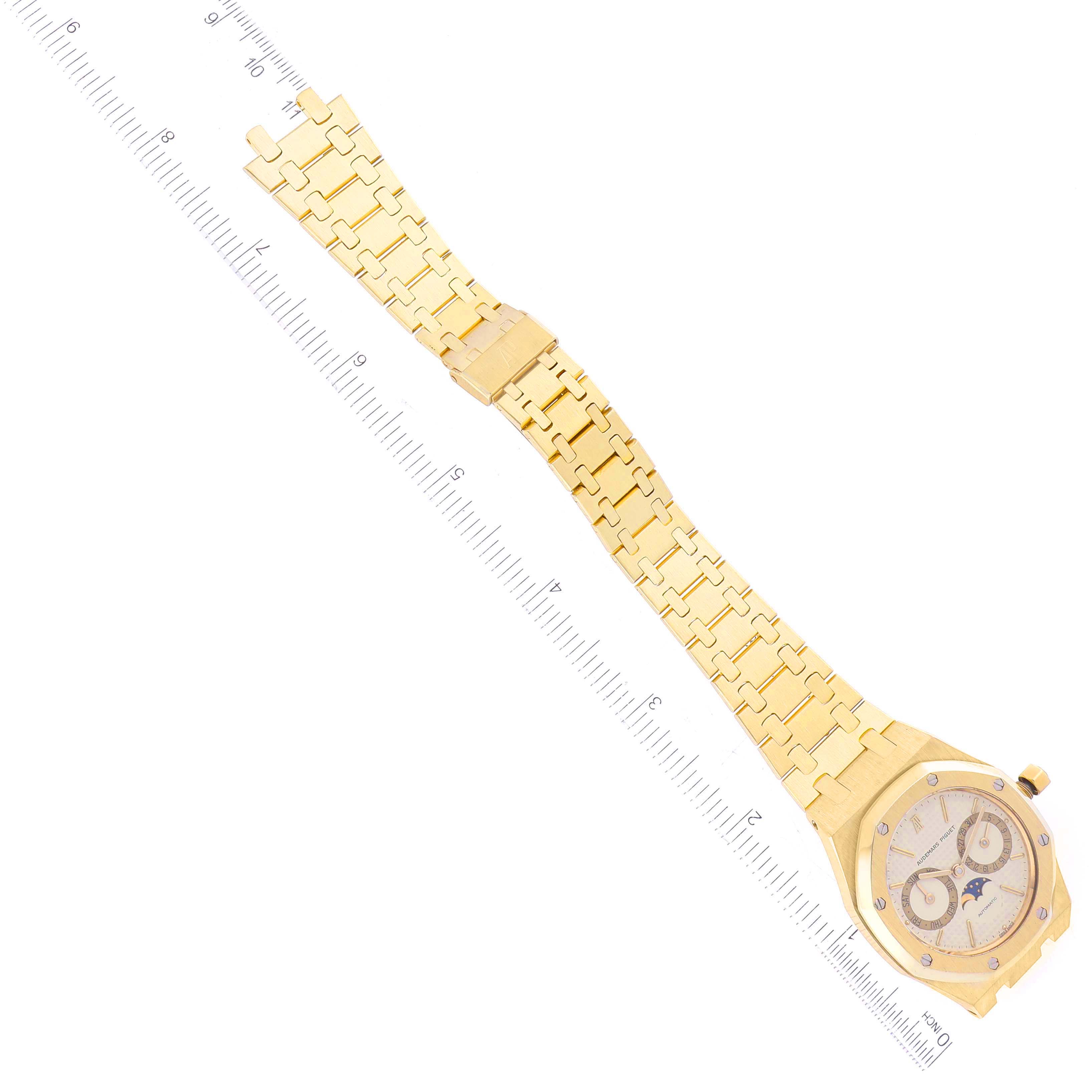 The image shows a top-down view of an Audemars Piguet Royal Oak 25594BA.OO.0477BA.01 Men's Yellow Gold Champagne Dial 25594BA.OO.0477BA.01 Men's Yellow Gold Champagne Dial watch, displaying its dial, bezel, and bracelet alongside a ruler for scale.