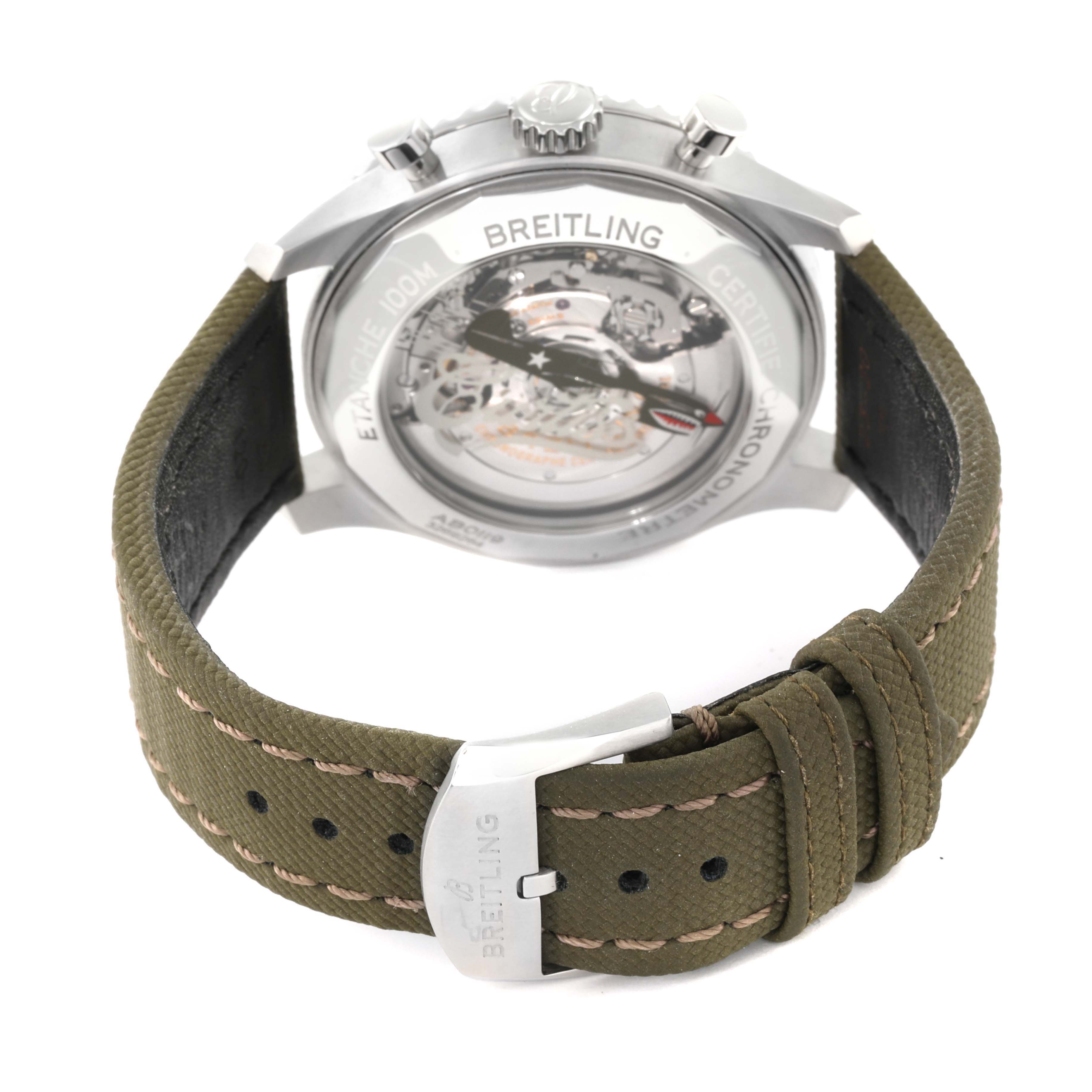 This image shows the back view of a Breitling Navitimer watch, displaying the transparent case back and green strap with the clasp.